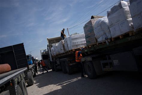 Egypt’s border crossing opens to let a trickle of desperately needed aid into besieged Gaza